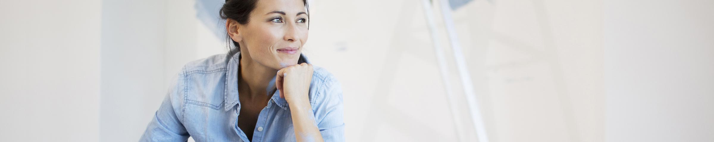 Woman sitting in a room she is re-painting