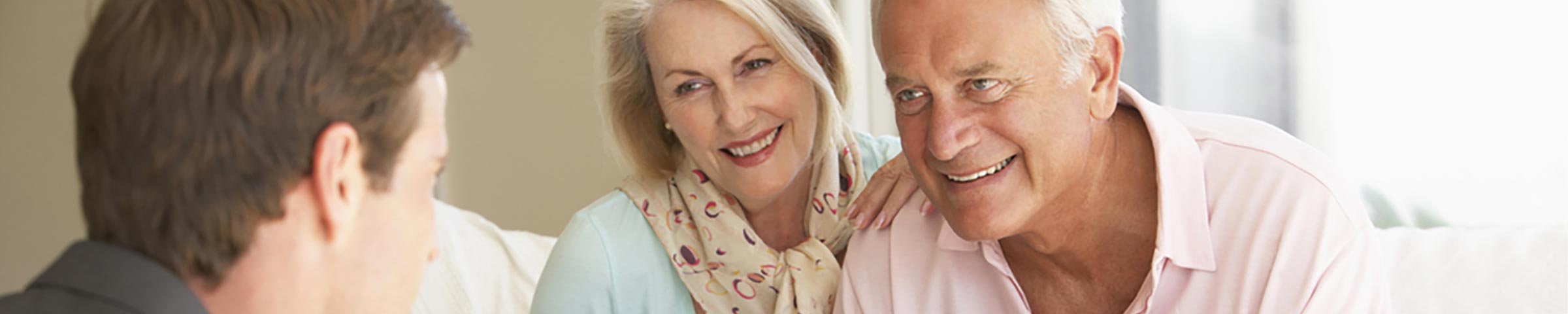 Advisor working on an estate plan with a retired couple in their home